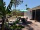 Private backyard with patio, mature trees, and seating area, perfect for outdoor enjoyment at 1805 Springwood Dr, Sarasota, FL 34232