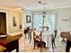 Bright dining area with a round table, neutral paint, tile flooring, and a large window at 1805 Springwood Dr, Sarasota, FL 34232