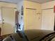 A garage with a door, two closets and vehicle visible in the foreground at 1805 Springwood Dr, Sarasota, FL 34232
