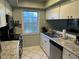 Well-lit kitchen with stainless steel appliances and durable countertops at 1805 Springwood Dr, Sarasota, FL 34232