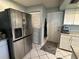 Bright kitchen features a stainless steel refrigerator and ample cabinet space at 1805 Springwood Dr, Sarasota, FL 34232