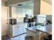 Functional kitchen with white cabinetry, sleek appliances, and granite countertops, offering modern convenience at 1805 Springwood Dr, Sarasota, FL 34232