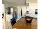 Cozy kitchen featuring stainless steel refrigerator and a wooden dining table, providing an inviting space at 1805 Springwood Dr, Sarasota, FL 34232