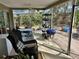 Relaxing screened-in porch with comfortable seating and space for outdoor dining at 1805 Springwood Dr, Sarasota, FL 34232