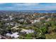 Elevated view of property highlighting lush landscaping, modern home design, pool, and surrounding cityscape at 1909 Field Rd, Sarasota, FL 34231