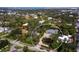 Expansive aerial view showcasing the house, its landscaping and the surrounding area in a neighborhood setting at 1909 Field Rd, Sarasota, FL 34231