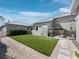 Backyard boasts an artificial lawn, a minimalist exterior and a serene space at 1909 Field Rd, Sarasota, FL 34231