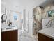 Luxurious bathroom showcasing a marble tile shower, double vanity, and elegant fixtures at 1909 Field Rd, Sarasota, FL 34231