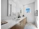Bright bathroom featuring a double vanity, quartz counters, and stylish tile flooring at 1909 Field Rd, Sarasota, FL 34231