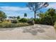 Gravel driveway leads to a lushly landscaped yard and a partially visible modern home at 1909 Field Rd, Sarasota, FL 34231