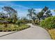 Long driveway lined with lush landscaping leading to this beautiful home provides a grand entrance at 1909 Field Rd, Sarasota, FL 34231