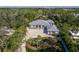 An elegant single Gathering home with lush landscaping, circular driveway and gated entrance at 1909 Field Rd, Sarasota, FL 34231