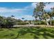Well-maintained front yard with flowering bushes and manicured lawn offer great curb appeal at 1909 Field Rd, Sarasota, FL 34231