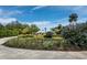 Beautifully landscaped front yard featuring lush gardens and a glimpse of a modern home at 1909 Field Rd, Sarasota, FL 34231