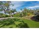 Expansive green lawn with mature trees and landscaping providing a serene setting for this home at 1909 Field Rd, Sarasota, FL 34231