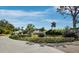 Beautifully landscaped front yard with flowering plants and mature trees in a tropical setting at 1909 Field Rd, Sarasota, FL 34231
