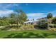 Beautiful Florida home with lush landscaping and a manicured front yard beneath a bright blue sky at 1909 Field Rd, Sarasota, FL 34231