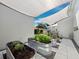 Backyard garden featuring galvanized steel planters with lush greenery, providing a tranquil outdoor space at 1909 Field Rd, Sarasota, FL 34231