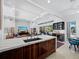 Open-concept kitchen and living area with a kitchen island, modern finishes, and natural light at 1909 Field Rd, Sarasota, FL 34231