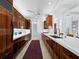 Chef's kitchen featuring custom wood cabinets, marble countertops, and high-end appliances at 1909 Field Rd, Sarasota, FL 34231