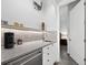 Convenient kitchenette with speckled counters, a stainless-steel sink, and built-in beverage cooler at 1909 Field Rd, Sarasota, FL 34231
