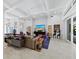 Open-concept living room featuring stylish decor, a large TV, and plenty of natural light at 1909 Field Rd, Sarasota, FL 34231