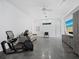 Spacious living room with ample natural light, neutral color palette, and home gym equipment at 1909 Field Rd, Sarasota, FL 34231