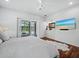 Bright main bedroom with sliding glass door access to the pool area and a modern beach vibe at 1909 Field Rd, Sarasota, FL 34231