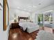 Spacious main bedroom with hardwood floors, natural light, and a sliding door to the pool area at 1909 Field Rd, Sarasota, FL 34231