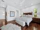 Spacious main bedroom featuring hardwood floors, a plush bed, and ample natural light at 1909 Field Rd, Sarasota, FL 34231