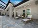 Covered patio features lounge chairs and dining area, perfect for outdoor living and entertaining at 1909 Field Rd, Sarasota, FL 34231