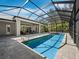 Enclosed pool with a spa and open patio area, perfect for relaxation and entertaining at 1909 Field Rd, Sarasota, FL 34231