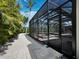 Enclosed pool area with patio, featuring screened walls with lovely view of the backyard at 1909 Field Rd, Sarasota, FL 34231
