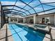 Enclosed pool with a spa, bar and open patio area, perfect for relaxation and entertaining at 1909 Field Rd, Sarasota, FL 34231