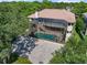 Aerial view of a luxury home with a screened lanai, pool, and green landscaping at 1930 Bayshore Dr, Englewood, FL 34223