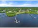 Beautiful waterfront homes nestled among lush greenery, featuring private docks and serene views, offering an idyllic retreat at 1930 Bayshore Dr, Englewood, FL 34223