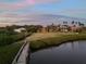 Beautiful waterfront homes featuring lush greenery, expansive lawns, and private docks at sunset at 1930 Bayshore Dr, Englewood, FL 34223