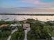Stunning aerial view of waterfront homes with lush landscaping and private boat docks at 1930 Bayshore Dr, Englewood, FL 34223