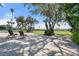 Large backyard with brick patio, lawn and view of the water at 1930 Bayshore Dr, Englewood, FL 34223