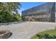 Wide shot of backyard with fire pit, patio and view of the screened-in pool at 1930 Bayshore Dr, Englewood, FL 34223