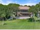 Expansive screened-in lanai with pool, and spacious patio surrounded by lush greenery and mature trees creates a private outdoor oasis at 1930 Bayshore Dr, Englewood, FL 34223