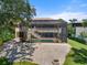 Spacious screened-in lanai with pool, and brick patio creates a perfect outdoor retreat at 1930 Bayshore Dr, Englewood, FL 34223