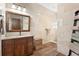 Modern bathroom featuring a wooden vanity, granite countertop, stone tile shower, and wood-look tile floors at 1930 Bayshore Dr, Englewood, FL 34223