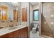 Bathroom featuring a shower, toilet and a window above toilet for natural light at 1930 Bayshore Dr, Englewood, FL 34223