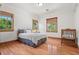 Bright bedroom with hardwood floors, natural light, and a crib at 1930 Bayshore Dr, Englewood, FL 34223