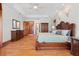 Spacious bedroom featuring a tray ceiling, hardwood floors, and ample closet space at 1930 Bayshore Dr, Englewood, FL 34223