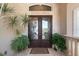 Elegant double front doors with decorative glass and lush plants on a tiled porch at 1930 Bayshore Dr, Englewood, FL 34223