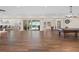 Spacious game room with wood floors, pool table, and access to outdoor spaces at 1930 Bayshore Dr, Englewood, FL 34223