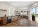 Well-lit kitchen with wood cabinets, stainless steel appliances, large windows, and tile floors at 1930 Bayshore Dr, Englewood, FL 34223
