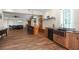 Open-concept kitchen with wood cabinets, bar seating, and access to the living room at 1930 Bayshore Dr, Englewood, FL 34223